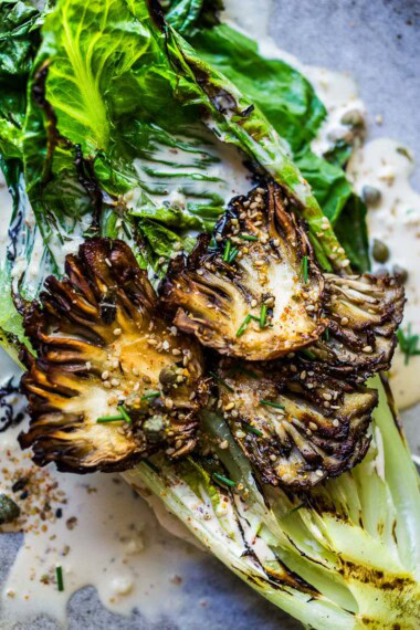 This Grilled Romaine Salad is topped with grilled Maitake Mushrooms—and tossed in a Furikake Caesar dressing that comes together in 20 minutes! Vegan-adaptable.