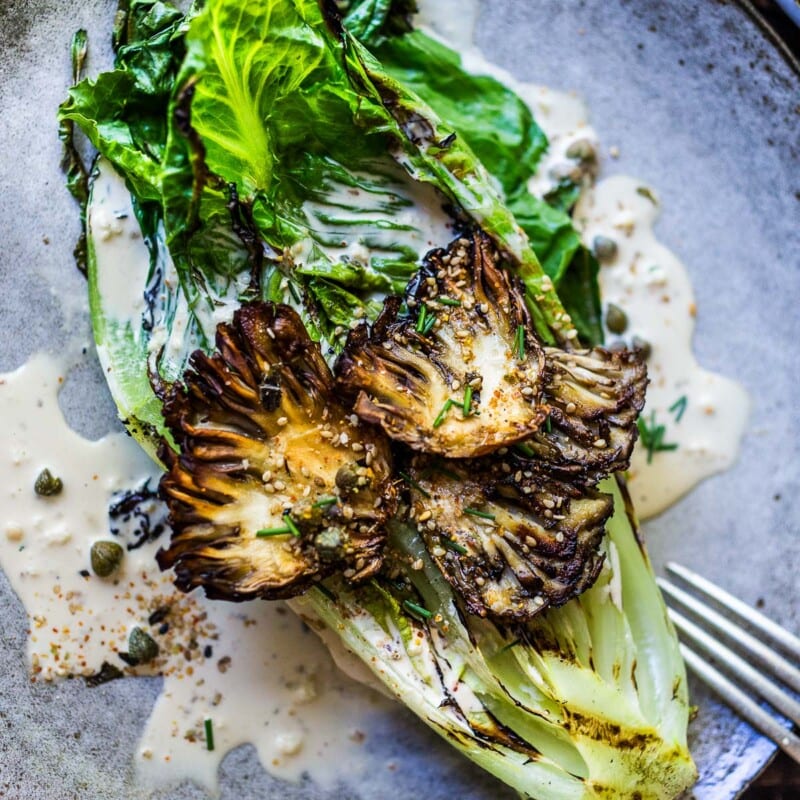 This Grilled Romaine Salad is topped with grilled Maitake Mushrooms—and tossed in a Furikake Caesar dressing that comes together in 20 minutes! Vegan-adaptable.