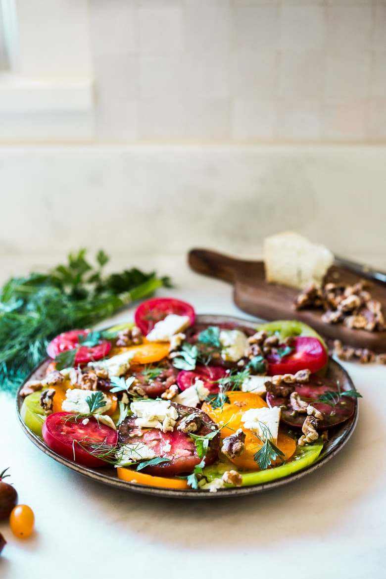 Heirloom Tomato Salad with Toasted Walnuts and Smoked Blue Cheese - a simple summer salad highlighting sweet and juicy heirloom tomatoes. Can be made in 15 minutes! #tomatosalad #tomatowalnutsalad #heirloomtomatosalad #summersalad #farmersmarketsalad #tomatorecipes #walnutsalad