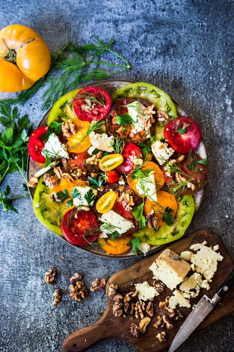 Heirloom Tomato Salad with Toasted Walnuts and Smoked Blue Cheese - a simple summer salad highlighting sweet and juicy heirloom tomatoes. Can be made in 15 minutes! #tomatosalad #tomatowalnutsalad #heirloomtomatosalad #summersalad #farmersmarketsalad #tomatorecipes #walnutsalad 