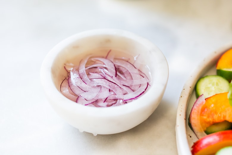 Nectarine Cucumber Salad with Basil, Goat Cheese, Red onion and optional Urfa Biber ( Turkish Chili Pepper). A simple delicious Farmers Market Salad you can put together in minutes! #nectarinesalad #nectarines #nectarinerecipes #farmersmarket #healthysalad #easysalads #cucumbersalad 