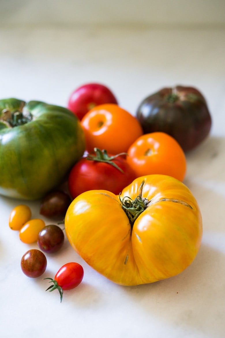 Heirloom Tomato Salad with Toasted Walnuts and Smoked Blue Cheese - a simple summer salad highlighting sweet and juicy heirloom tomatoes. Can be made in 15 minutes! #tomatosalad #tomatowalnutsalad #heirloomtomatosalad #summersalad #farmersmarketsalad #tomatorecipes #walnutsalad 