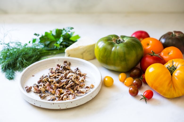 Heirloom Tomato Salad with Toasted Walnuts and Smoked Blue Cheese - a simple summer salad highlighting sweet and juicy heirloom tomatoes. Can be made in 15 minutes! #tomatosalad #tomatowalnutsalad #heirloomtomatosalad #summersalad #farmersmarketsalad #tomatorecipes #walnutsalad 