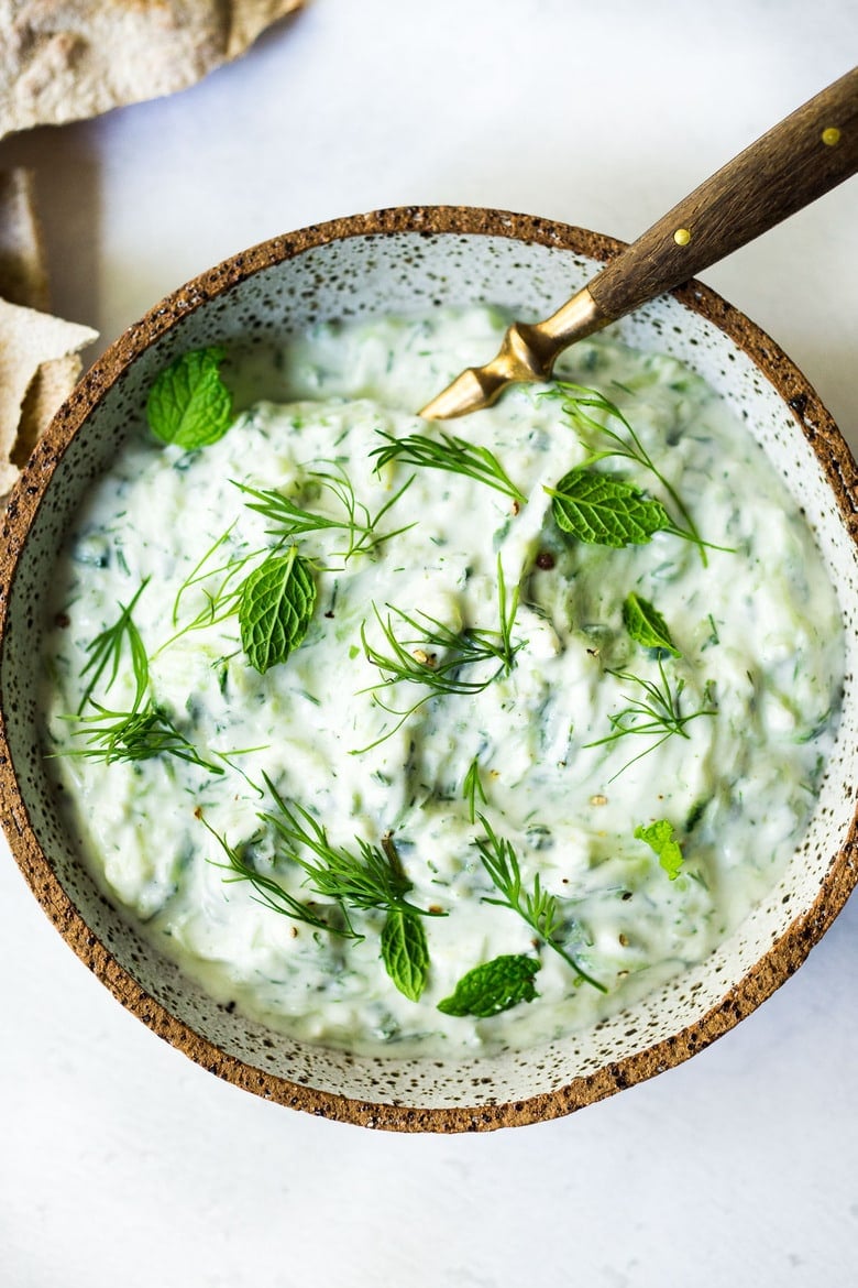 The Best Tzatziki Sauce! An easy, healthy, Greek cucumber-yogurt sauce to use in mezze platters, wraps, gyros, or as a simple dip for pita, or as a delightful side to Mediterranean dishes. This SIMPLE recipe can be made in 15 minutes! #tzatziki #tzatzikirecipe #tzatzikisauce #easy #cucumbersalad 