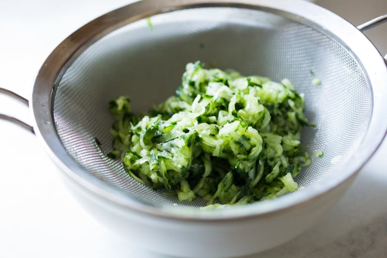 grating, salting and straining the cucumber