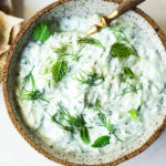 Authentic Tzatziki Sauce - a healthy, flavorful Greek cucumber-yogurt sauce to use in wraps and gyros, or as a dip for pita, or as a delicious side to Mediterranean dishes. This simple EASY recipe can be made in 15 minutes! #tzatziki #tzatzikirecipe #tzatzikisauce #easy #cucumbersalad