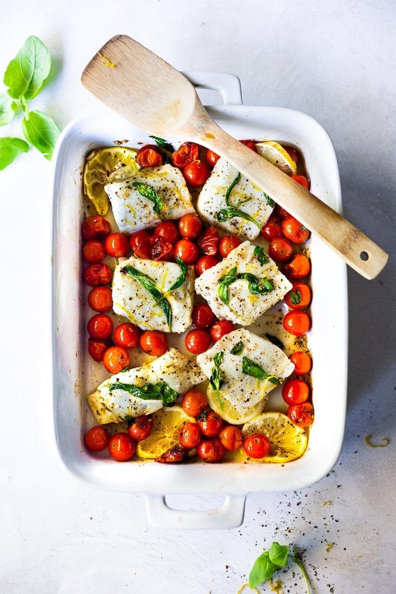 Simple Baked Cod with Tomatoes, Basil, Garlic and Lemon- a fast and easy weeknight dinner that is healthy and delicious! #bakedcod #bakedfish #keto #keporecipes #weeknightdinner #weeknightdinners #easyfishrecipes 
