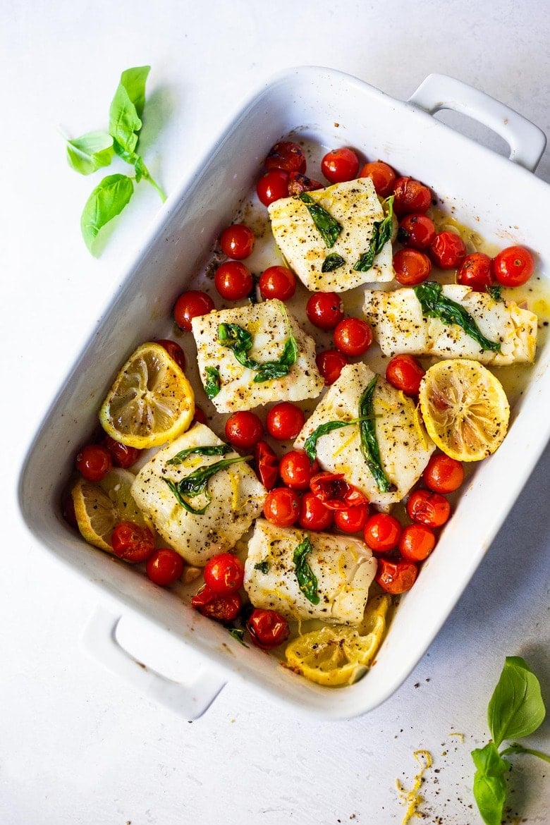 Simple Baked Cod with Tomatoes, Basil, Garlic, and Lemon- a fast and easy weeknight dinner that is healthy and delicious! #bakedcod #bakedfish #keto #keporecipes #weeknightdinner #weeknightdinners #easyfishrecipes 
