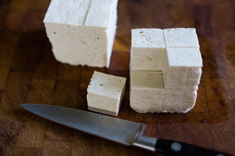 Here's a simple easy recipe for Crispy Tofu that can be made on the stovetop in 20 minutes with just 3 ingredients. You'll find a million uses for this crispy tofu and fun ways to season it - adding it to meals you are already making. #crispytofu #simpletofurecipes #easytofu #tofu #tofurecipes #friedtofu #stirfriedtofu