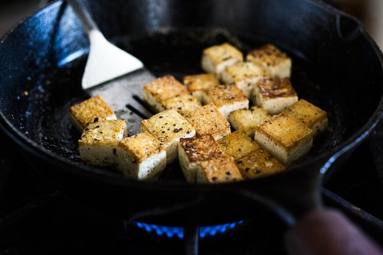 Here's a simple easy recipe for Crispy Tofu that can be made on the stovetop in 20 minutes with just 3 ingredients. You'll find a million uses for this crispy tofu and fun ways to season it - adding it to meals you are already making. #crispytofu #simpletofurecipes #easytofu #tofu #tofurecipes #friedtofu #stirfriedtofu