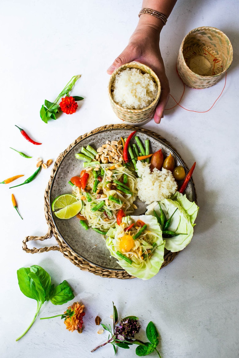 This Thai green papaya salad (Som Tam) is bright, crunchy, and refreshing with lime, chili, fish sauce, and roasted peanuts. Easy and authentic. Vegan-adaptable and gluten-free.
