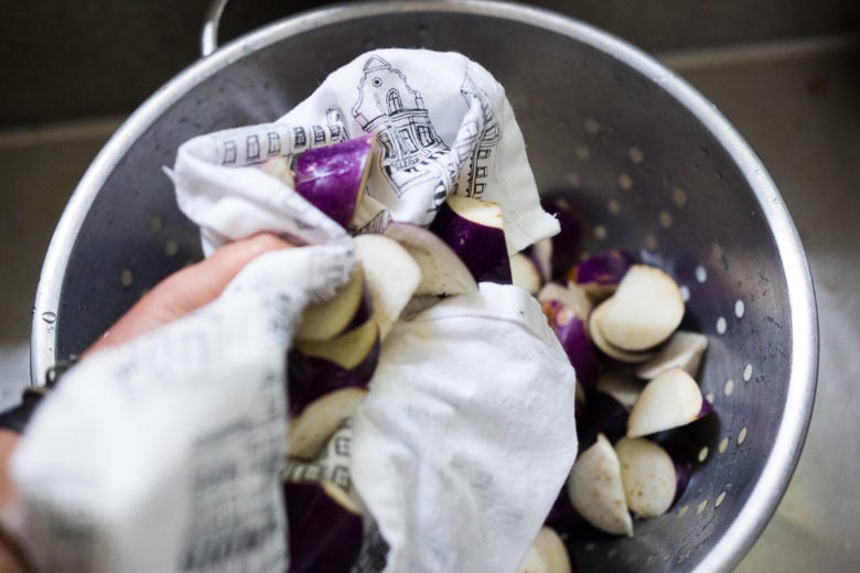 Drying the cut Chinese eggplant.