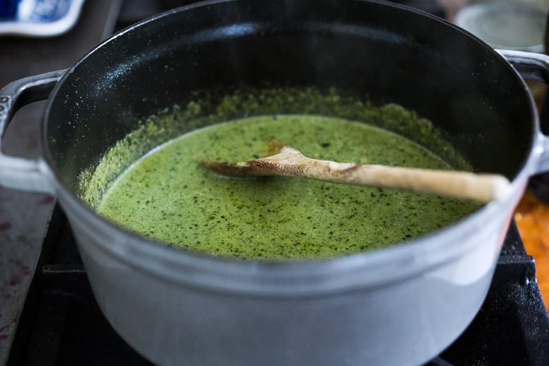 green curry paste and broth in a pot
