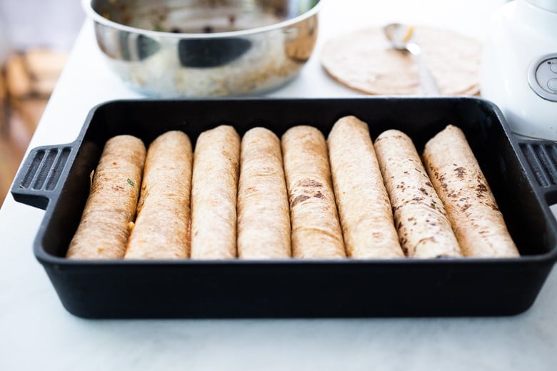rolled enchiladas in the baking dish.