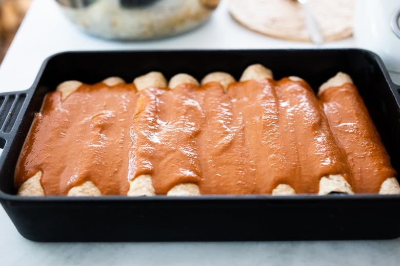 Enchiladas topped with the enchilada sauce.