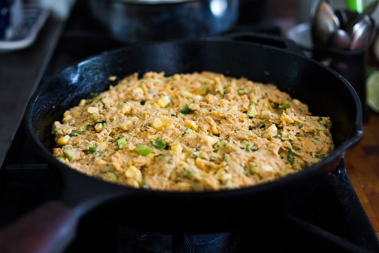 Zucchini Cornbread! A savory zucchini bread infused with Mexican spices, cornmeal, fresh corn and sharp cheddar cheese, baked in a skillet. A cozy side to stew, soup and chili.