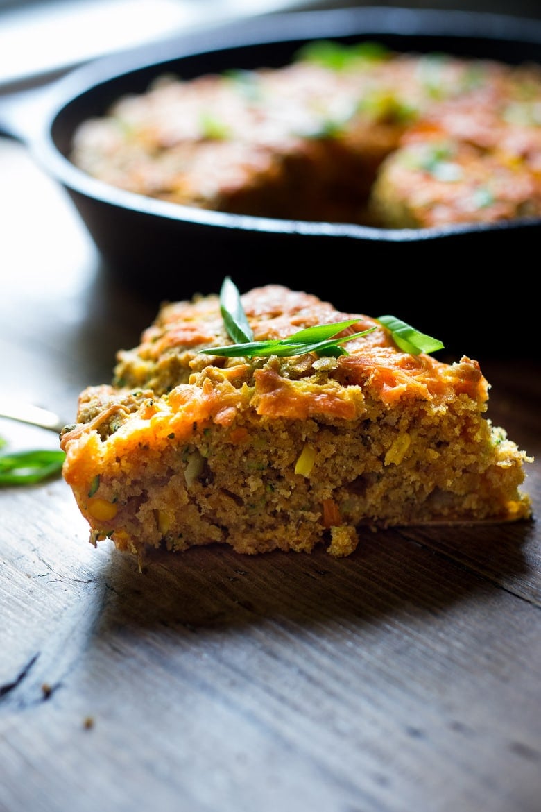 20 healthy Zucchini Recipes: Zucchini Cornbread- A savory zucchini bread infused with Mexican spices, cornmeal, fresh corn and sharp cheddar cheese, baked in a skillet. A cozy side to stew, soup and chili. 