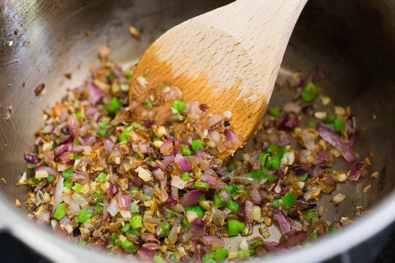 Sautéing spices with ghee for Chana Masala.