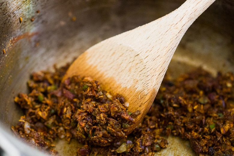 Sautéing spices with ghee for Chana Masala.