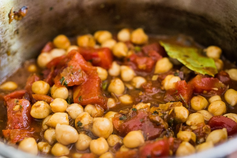 Chana masala simmering in pot.
