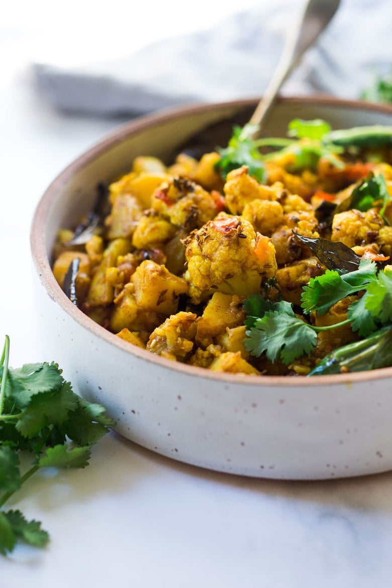 Flavorful Aloo Gobi! Indian-Spiced Potatoes and Cauliflower with Masala Spices- an easy authentic healthy Indian classic that can be made on the stovetop! Vegan adaptable. #aloo #aloogobi #aloogobimasala #indianfood #potatorecipes #cauliflowerrecipes #vegetarian 