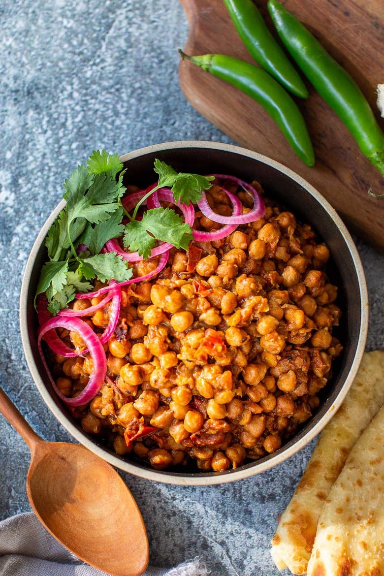 This authentic Chana Masala Recipe can be made in an Instant pot or on the stove top. A quick and easy Vegetarian dinner recipe that is full of amazing Indian flavor! #chanamasala #chana #vegetariandinner 