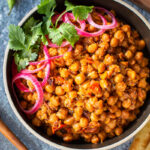 This authentic Chana Masala Recipe can be made in an Instant pot or on the stove top. A quick and easy Vegetarian dinner recipe that is full of amazing Indian flavor! #chanamasala #chana #vegetariandinner