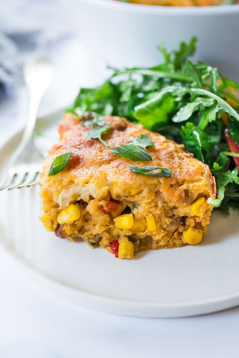 Cornbread Casserole! Seasoned with Mexican spices and filled with healthy veggies and cheddar cheese, this easy corn casserole can be put together in just 20 minutes before baking in the oven. #weeknightdinner #weeknightmeal #vegetariandinner #vegetarian #cornbread #corncasserole #cornbreadcasserole 