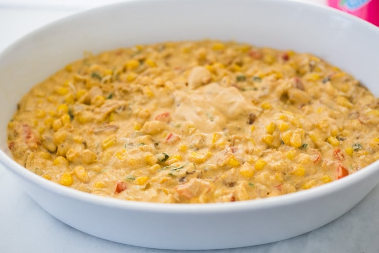 Corn bread casserole going into an oven