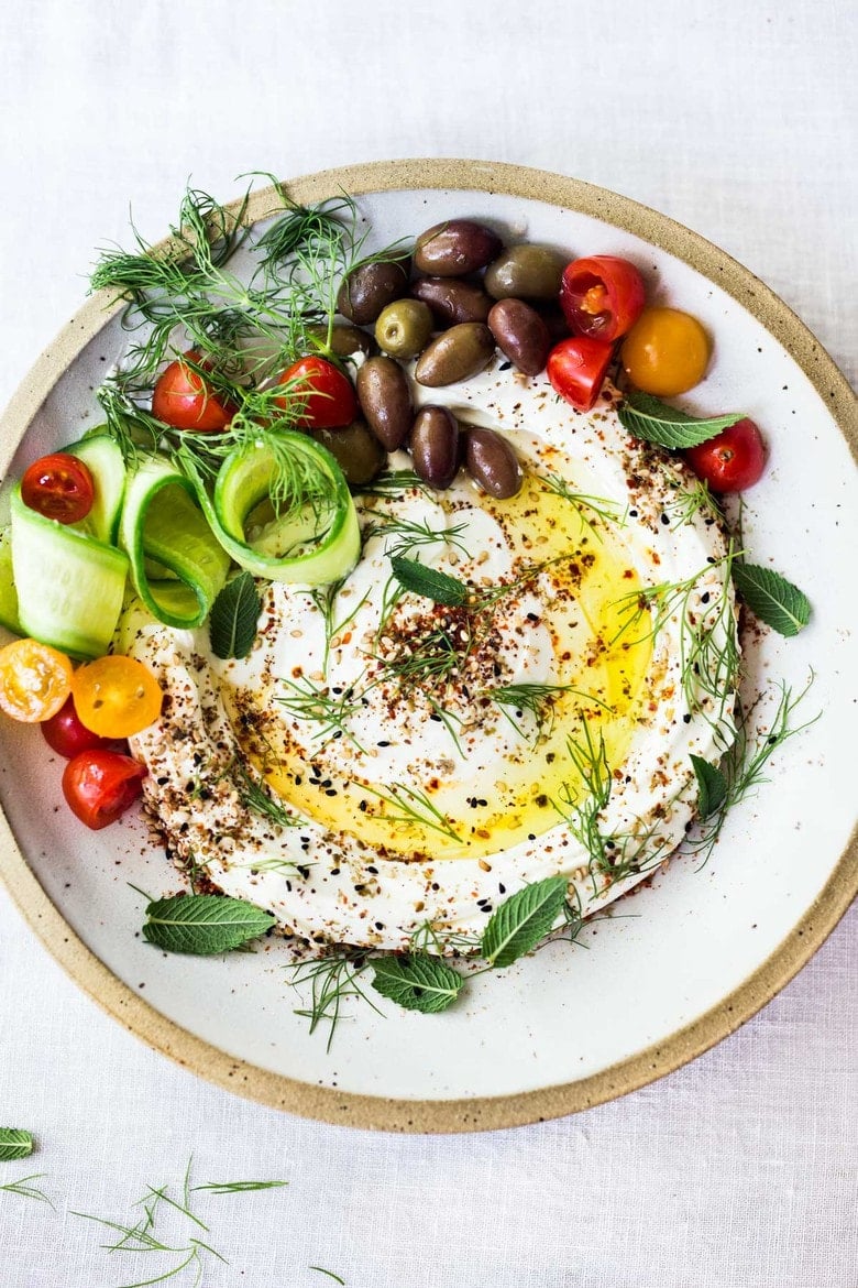 25 Appetizers to Bring to a Party! | Labneh! A creamy Middle Eastern Yogurt Dip (or cheese) with olive oil, zaatar spice and fresh herbs served with crunchy veggies or toasted pita.