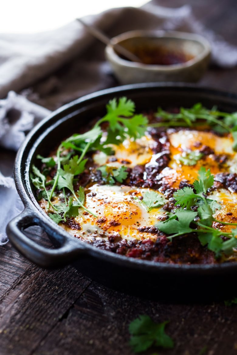 Moroccan Eggs! Eggs are baked in a flavorful lamb stew infused with Moroccan Spices, topped with Harissa Yogurt. A delicious breakfast or brunch recipe. #moroccanrecipes #bakedeggs #lambrecipes #groundlamb #brunch #breakfastrecipes 