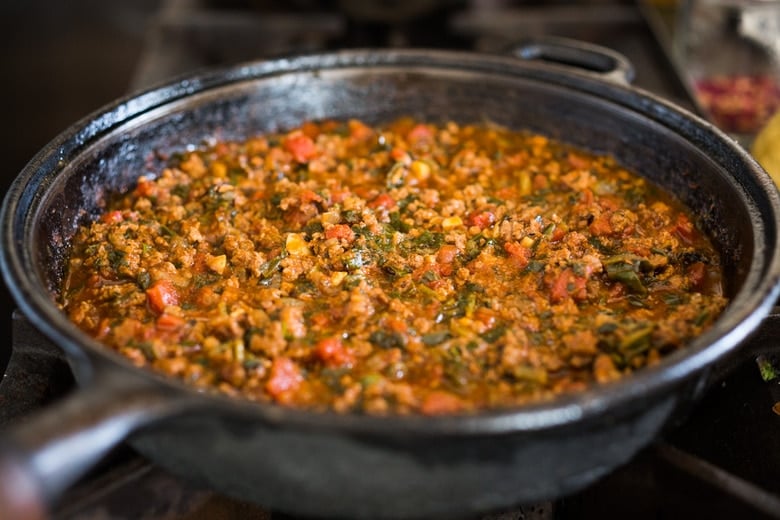 Moroccan Eggs! Eggs are baked in a flavorful lamb stew infused with Moroccan Spices, topped with Harissa Yogurt. A delicious breakfast or brunch recipe. #moroccanrecipes #bakedeggs #lambrecipes #groundlamb #brunch #breakfastrecipes 