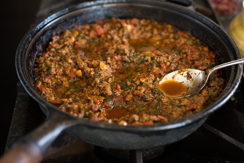 Moroccan Eggs! Eggs are baked in a flavorful lamb stew infused with Moroccan Spices, topped with Harissa Yogurt. A delicious breakfast or brunch recipe. #moroccanrecipes #bakedeggs #lambrecipes #groundlamb #brunch #breakfastrecipes 