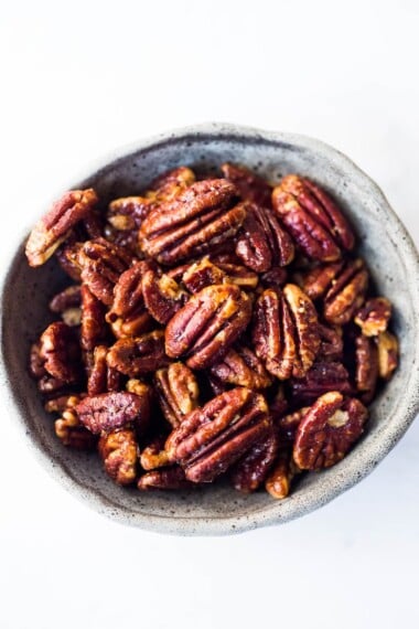 EASY Candied Pecans made in just 15 minutes in the Oven. Only 3 ingredients! Oil free, Sugar Free, Vegan and totally foolproof! The BEST recipe that comes out perfect every time! #candiedpecans #maplepecans