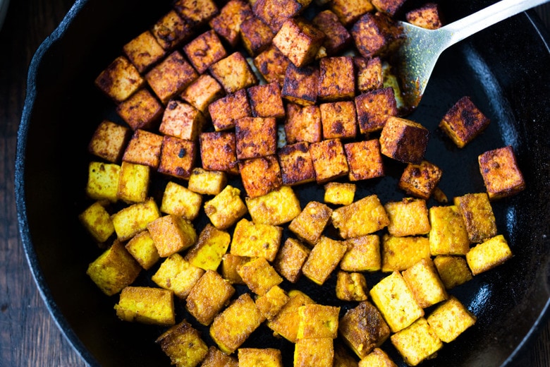 How to make flavorful Crispy Tofu on the stovetop in 20 minutes! You'll find a million uses for this crispy tofu and fun ways to season it - adding it to meals you are already making. #crispytofu #simpletofurecipes #easytofu #tofu #tofurecipes #friedtofu #stirfriedtofu