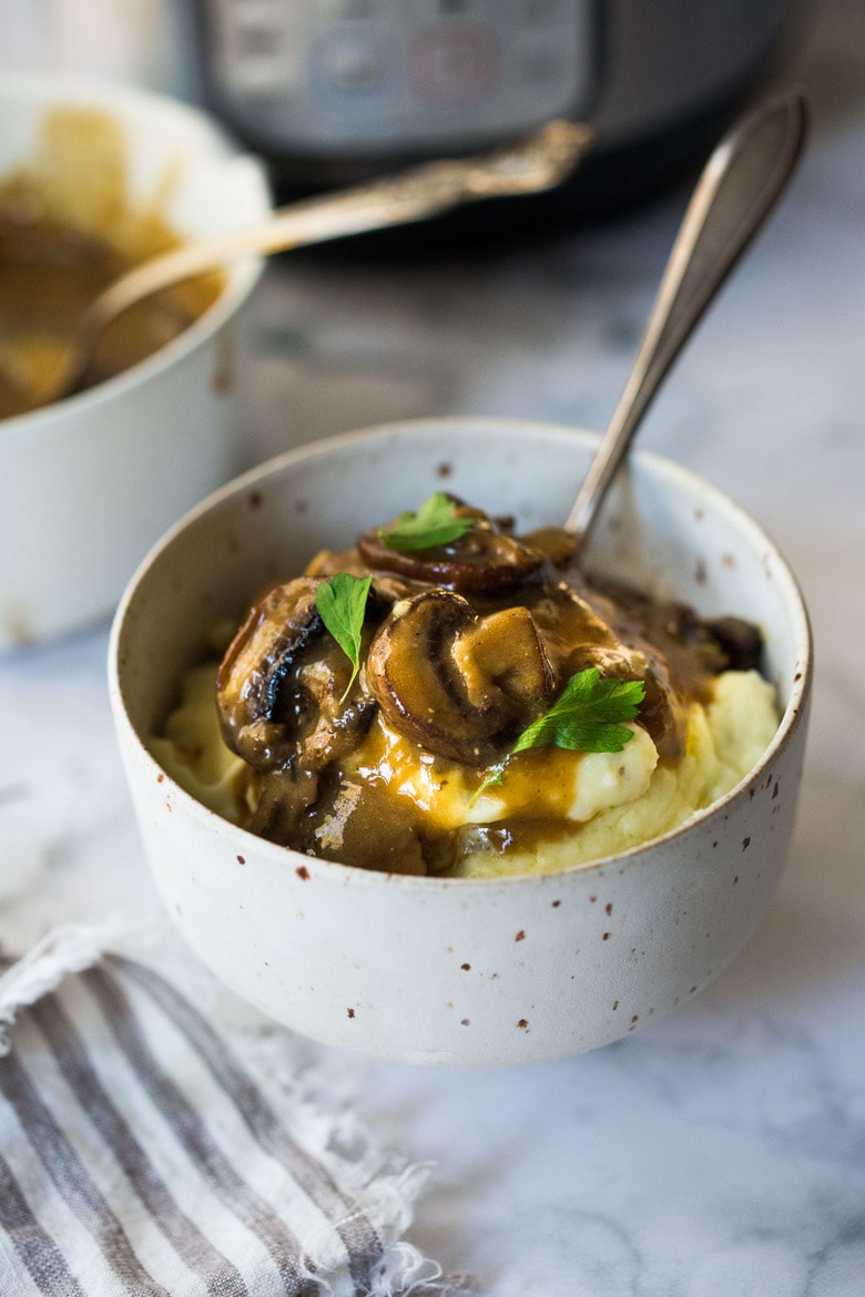 Instant Pot Mashed Potatoes in a bowl with gravy. 