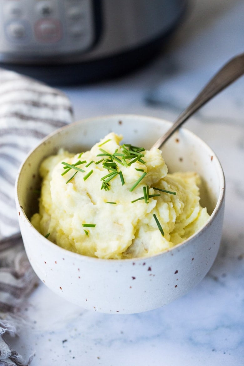 Easy Instant Pot Mashed Potatoes- creamy, fluffy and light and can be made in 20 minutes! Boost their flavor with roasted garlic, goat cheese, or horseradish! Up to you! Vegan adaptable and gluten free! #mashedpotatoes #instantpot #sides #thanksgivingsides #sidedishes #veganmashedpotatoes