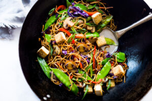 Veggie Lo Mein! On the table in under 20 minutes! Loaded up with healthy veggies, this VEGAN dinner recipe is fast and easy, perfect for busy weeknights! #lomein #lomeinnoodles #vegandinner #veganrecipes #veganlomein #stirfry