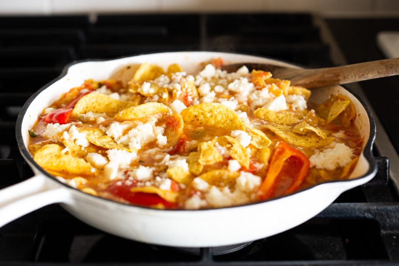 How to Make Chilaquiles! A classic Mexican dish made with stewed corn tortillas (or chips) that can be served as breakfast, lunch or dinner. The best part? This highly adaptable meal can be made in under 20 minutes, perfect for busy weeknights! #chilaquiles #vegetarian #mexican #rojo #verde