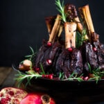 Oven Braised Lamb Shanks with Pomegranate - a festive, Moroccan-inspired lamb recipe that is elegant and delicious! Succulent lamb shanks are roasted in the oven until tender and falling off the bone then drizzled with a falvorful pomegranate sauce. Serve over creamy soft polenta. #lambshanks #moroccanlamb #braisedlamb #lambrecipes #bakedlamb #lambrecipes #lamb