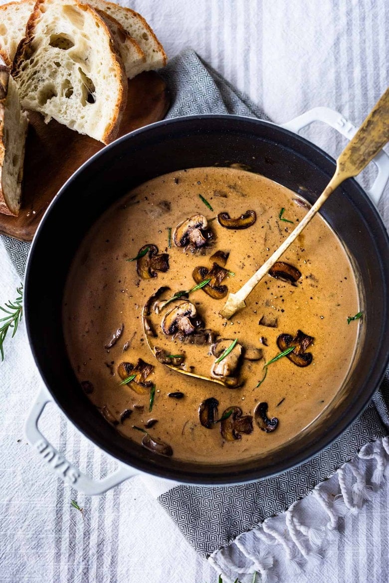 Creamy Mushroom Soup with Rosemary and Garlic - a delicious easy recipe that is Keto friendly and perfect for special  gatherings or simple enough for weeknight dinners! Serve this with crusty bread for a simple hearty meal!  #mushroomsoup #mushroomsouprecipe #mushroomrecipes #ketosoup