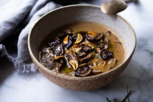 Creamy Mushroom Soup with Rosemary and Garlic - a delicious easy recipe that is Keto friendly and perfect for special  gatherings or simple enough for weeknight dinners! Serve this with crusty bread for a simple hearty meal!  #mushroomsoup #mushroomsouprecipe #mushroomrecipes #ketosoup