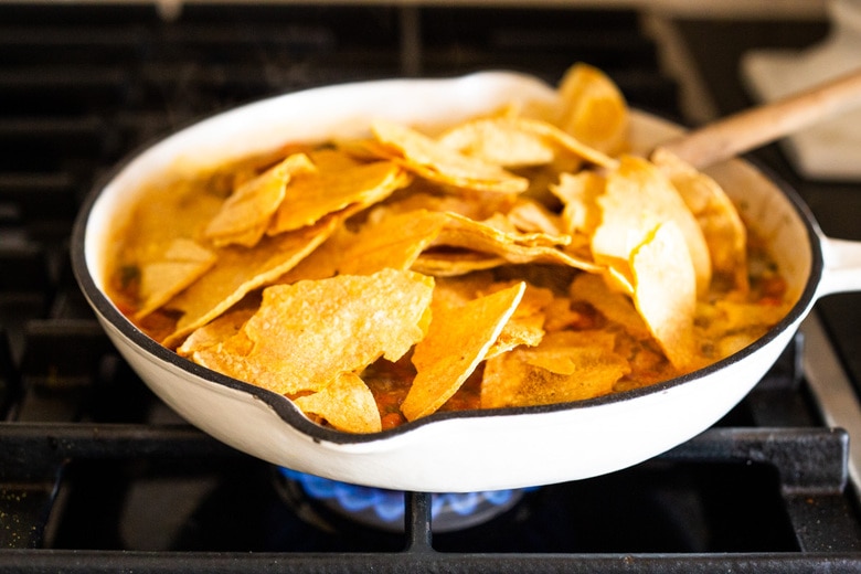 How to Make Chilaquiles! A classic Mexican dish made with stewed corn tortillas (or chips) that can be served as breakfast, lunch or dinner. The best part? This highly adaptable meal can be made in under 20 minutes, perfect for busy weeknights! #chilaquiles #vegetarian #mexican #rojo #verde