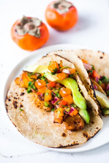 Fish Tacos with Persimmon Tacos -How to make the most delicious salsa in winter, using Fuyu Persimmons instead of tomatoes! Easy, quick and flavorful! Use this on fish tacos or like you would Pico de Gallo. #salsa #persimmons #persimmonrecipes #picodegallo