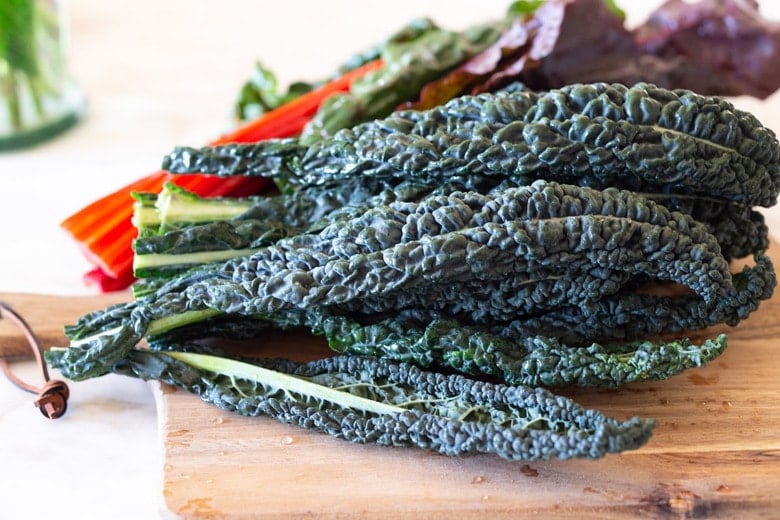 Sautéed kale and chard with garlic, shallots and lemon - a simple side dish that is vegan, low carb, Keto and full of healthy nutrients! Delicious flavor and can be made in 20 minutes! #sautéedkale #sautéedgreens, #wiltedkale, #ketosidedish, #vegansidedish,