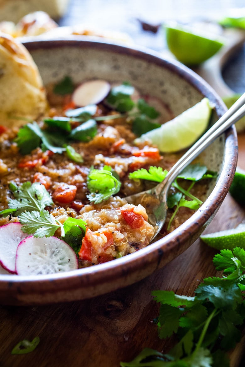 This hearty nourishing Moroccan Red Lentil Quinoa Soup is vegan, easy to make and made with simple everyday ingredients. Flavorful and aromatic, the warming spices are especialluy cozy. This can be made in under 30 minutes in an Instant Pot or on the stovetop and keeps well for midweek meals. #vegansoup #redlentisoup #quinoasoup #moroccansoup #moroccanstew #veganstew #instantpotsoup #instantpot 