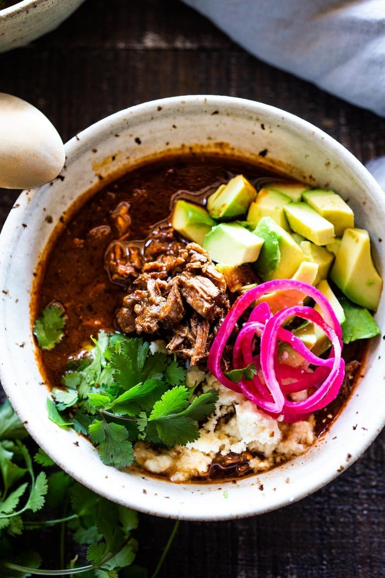 An authentic recipe for Birria, a flavorful Mexican Stew made with beef, lamb or goat, that can be made in an Instant Pot, Dutch Oven or Slow Cooker. Serve this in a big bowl or make Birria Tacos - the best! #birria #birriatacos #mexicanstew #tacos 