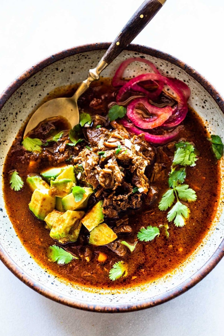 An authentic recipe for Birria, a flavorful Mexican Stew made with beef, lamb or goat that can be made in an Instant Pot, Dutch Oven or Slow Cooker. Serve this in a big bowl or make Birria Tacos - the best! #birria #birriatacos #mexicanstew #tacos