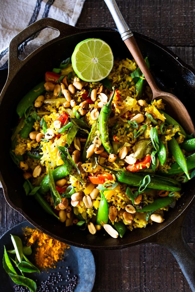 This fragrant, turmeric-infused, Indian Fried Rice is full of healthy veggies and can be made in under 30 minutes. Vegetarian, Gluten-free and Vegan adaptable, it is a fast and easy weeknight meal- great for using up leftover rice and veggies in the fridge.  #turmericrice #veggierice #friedrice #vegandinner 