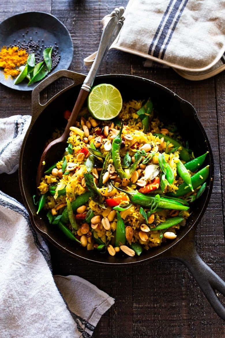 This fragrant, turmeric-infused, Indian Fried Rice is full of healthy veggies and can be made in under 30 minutes. Vegetarian, Gluten-free and Vegan adaptable, it is a fast and easy weeknight meal- great for using up leftover rice and veggies in the fridge.  #turmericrice #veggierice #friedrice #vegandinner 